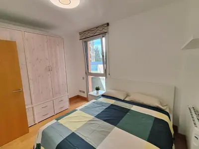 a bedroom with a bed and a window at Family apartment Forum in Sant Adria de Besos