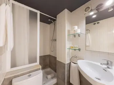a bathroom with a sink and a shower and a toilet at Stay U-nique Apartments Nació in Barcelona