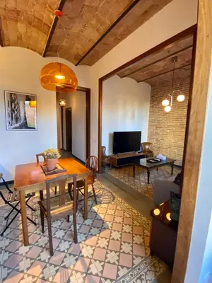 a room with a bed and a table and a window at Piso en Poblenou, Playa a 5 min in Barcelona