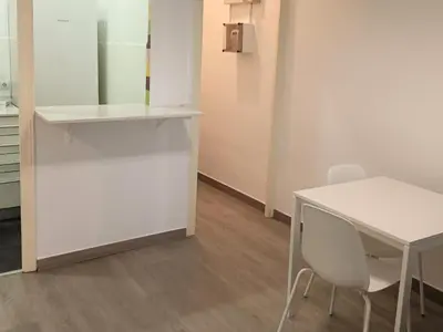 a white desk and a white table and chair in a room at Suitur apartamento floridablanca barcelona in Barcelona