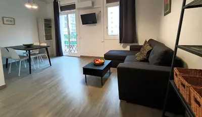 a living room with a couch and a table at Suitur apartamento floridablanca barcelona in Barcelona