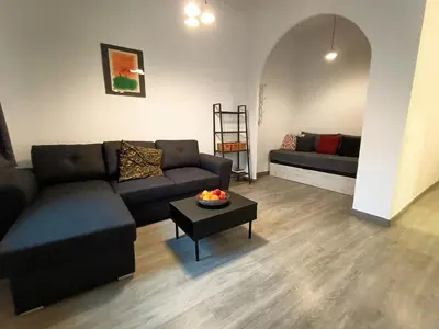 a living room with a couch and a table at Suitur apartamento floridablanca barcelona in Barcelona