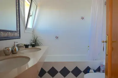 a bedroom with a bed and a television and a window at Habitación Atalaya in Olivella