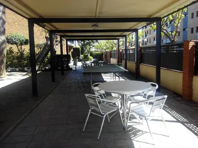 a table and chairs sitting on a patio at Apartamento Cabrera Montserrat in Cabrera de Mar