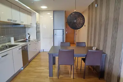 a kitchen with a table and chairs in a kitchen at Fira Gran Via - Barcelona4Seasons in Hospitalet de Llobregat
