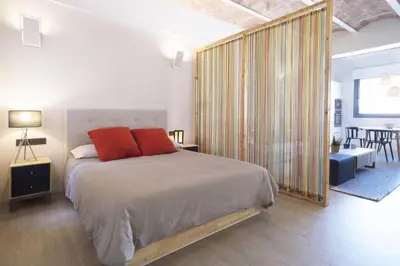 a bedroom with a large bed with orange pillows at Barcelona InLoft in Barcelona