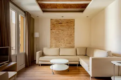a bathroom with a sink and a toilet and a mirror at Barcelona Apartment Milà in Barcelona