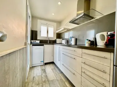 a kitchen with white cabinets and a sink at BarcelonaForRent Market Penthouse in Barcelona