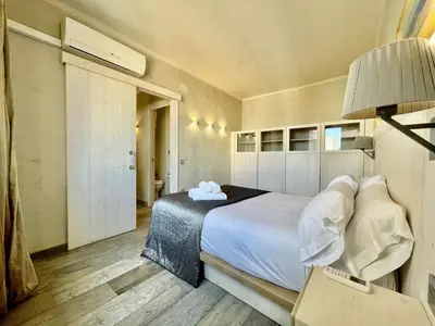 a bedroom with a large bed and a lamp at BarcelonaForRent Market Penthouse in Barcelona
