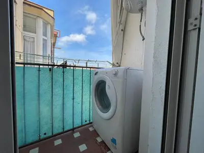 a washing machine sitting on a balcony next to a building at BarcelonaForRent Market Penthouse in Barcelona