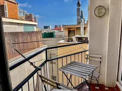 a balcony with a bench on a building at BarcelonaForRent Market Penthouse in Barcelona