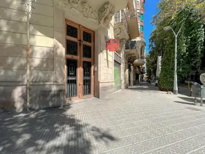a building with a red cross on the side of a street at Stay U-nique Apartment Tamarit in Barcelona