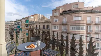 a table with a plate of food on a balcony at Stay U-nique Apartment Tamarit in Barcelona