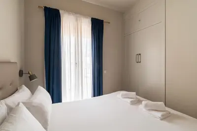 a bedroom with a large white bed and a window at Stay U-nique Apartments Torre d'En Damians II in Barcelona