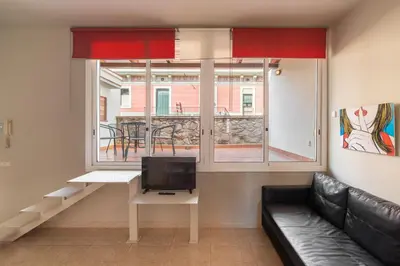 a living room with a couch and a tv and a window at Stay U-nique Apartments Torre d'En Damians II in Barcelona