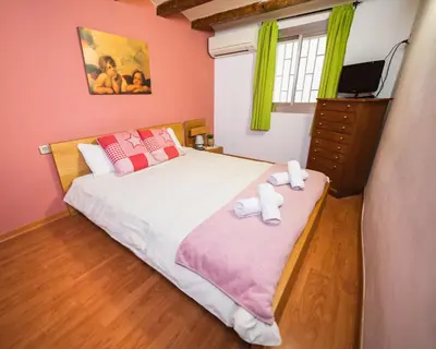a bedroom with a bed with two towels on it at Rustic Poble Sec Apartment in Barcelona