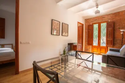 a room with a glass table and a bed at Eixample Sagrada Familia Apartments II in Barcelona