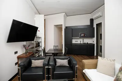 a living room with a couch and a tv at Classic styled apartment in Barcelona