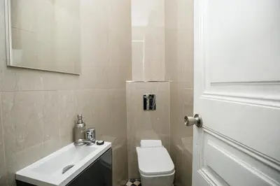 a bathroom with a white toilet and a sink at Classic styled apartment in Barcelona