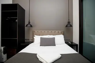 a bedroom with a bed with two towels on it at Classic styled apartment in Barcelona