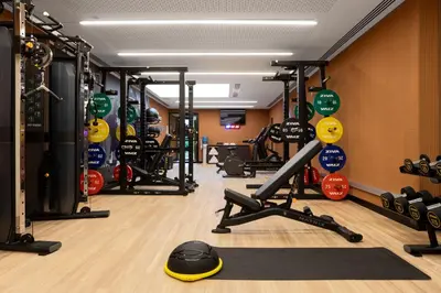a gym with a lot of treadmills and weights at Labtwentytwo Barcelona, a Tribute Portfolio Hotel in Barcelona