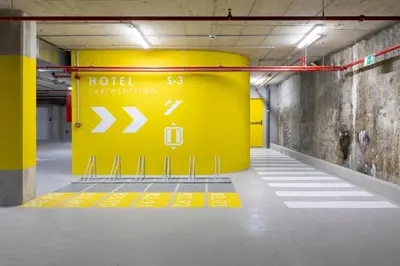 a large yellow sign in a parking garage at Labtwentytwo Barcelona, a Tribute Portfolio Hotel in Barcelona