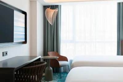 a hotel room with a tv and a bed and a desk at Labtwentytwo Barcelona, a Tribute Portfolio Hotel in Barcelona