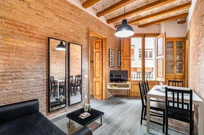 a living room with a couch and a dining room at Stay U-nique Apartment Ermengarda in Barcelona