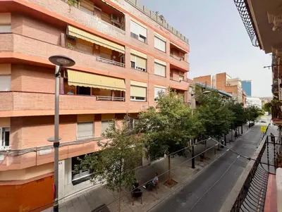 an empty street in front of a building at Stay U-nique Apartment Ermengarda in Barcelona