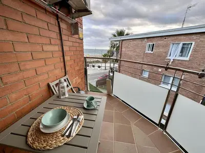 a balcony with a table with a bowl on it at Preciosas vistas al mar en Castelldefels in Castelldefels