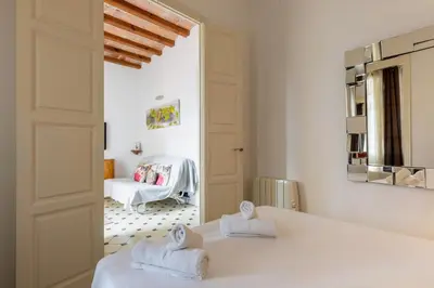 a bedroom with two beds with towels on them at Housalia Paseo de Gracia in Barcelona