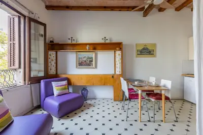 a living room with a purple chair and a table at Housalia Paseo de Gracia in Barcelona