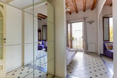 a room with a glass door and a couch at Housalia Paseo de Gracia in Barcelona