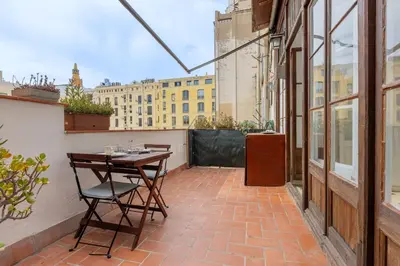 a patio with a table and chairs on a balcony at Housalia Paseo de Gracia in Barcelona