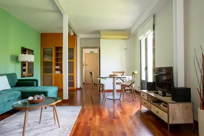 a living room with a blue couch and a table at The Luxury Open Space MACBA loft in Barcelona