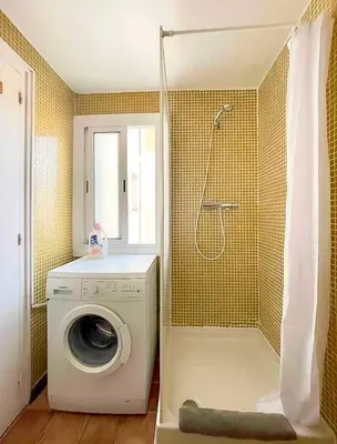 a washing machine in a bathroom with a shower at Barcelona Old Town attic near Catalunya square in Barcelona