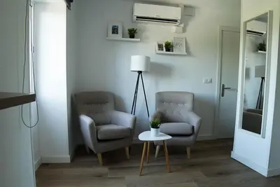 two chairs and a table in a living room at Apartament Roca Foradada in Monistrol