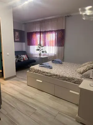 a bedroom with a bed and a couch at stop & go in Arbós