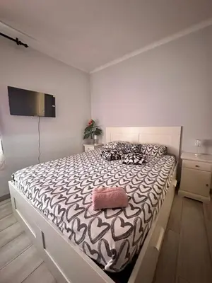 a bedroom with a bed with a black and white comforter at stop & go in Arbós