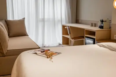 a hotel room with a bed with a book on it at La Florida Suites by Olala Homes in Hospitalet de Llobregat