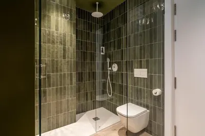 a bathroom with a shower with a toilet at La Florida Suites by Olala Homes in Hospitalet de Llobregat