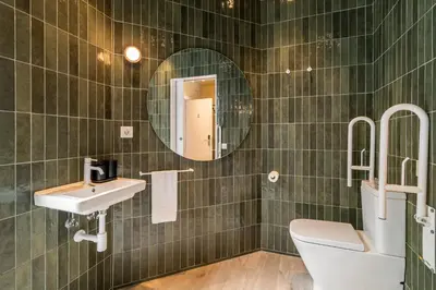 a bathroom with a sink and a toilet and a mirror at La Florida Suites by Olala Homes in Hospitalet de Llobregat