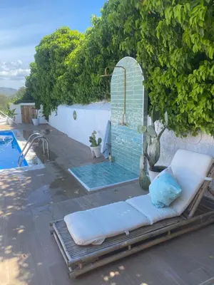 a couch sitting on a patio next to a pool at AMIRA home near Sitges in Sant Pere de Ribes