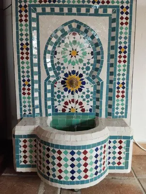 a tiled fountain in the middle of a room at AMIRA home near Sitges in Sant Pere de Ribes