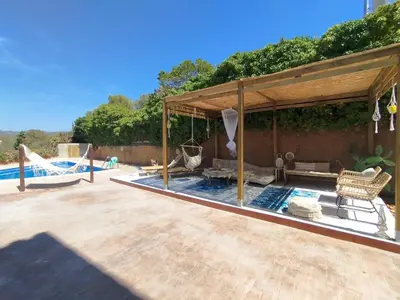 a swimming pool with a pavilion next to a pool at AMIRA home near Sitges in Sant Pere de Ribes