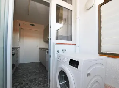 a white washer and dryer in a small kitchen at Santa Maria apartment in Vilassar de Mar