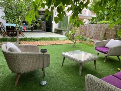 a yard with two chairs and a table and a couch at Lemon Tree GuestHouse in Tiana