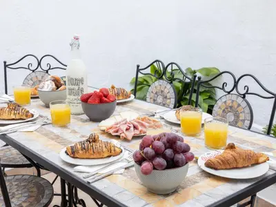 a table with plates of food and fruit on it at Matarolux24 in Mataró