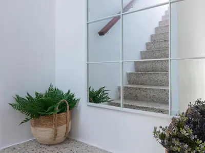 a stairwell with a mirror and a potted plant at Matarolux24 in Mataró