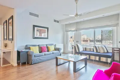 a living room with a couch and a table at Luxury Muntaner Plaza in Barcelona